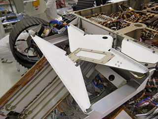 Image of bowtie-shaped antenna for the Radar Imager for Mars' Subsurface Experiment (RIMFAX) instrument mounted on the underside of the Perseverance rover. 