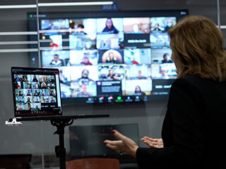 Image inside the control room for NASA's Perseverance rover showing NASA's Jet Propulsion Laboratory Director Dr. Laurie Leshin interacting virtually with student honorees.