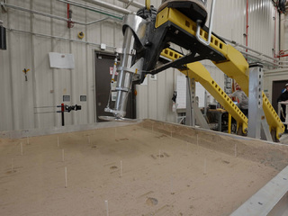 This setup is being used at JPL to test a 16-inch-diameter (40-centimeter-diameter) footpad for a future Mars lander. The footpad was plunged into a testbed filled with 10,000 pounds (4,536 kilograms) of simulated Martian soil in order to see how deep it would sink.