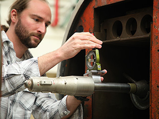 A scale model of the Mars Ascent Vehicle is loaded by Wind Tunnel Test Engineer Sam Schmitz into the trisonic wind tunnel at NASA’s Marshall Space Flight Center for testing.