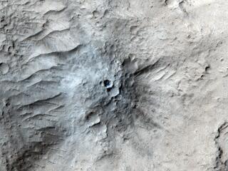 Captured by the HiRISE camera on NASAs Mars Reconnaissance Orbiter on March 4, 2021, this impact crater was found in Cerberus Fossae. Scientists matched its appearance on the surface with a quake detected by NASAs InSight lander.