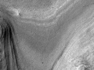 NASAs Curiosity rover appears as a dark speck in this view captured on Feb. 28, 2025, by the HiRISE camera aboard NASAs Mars Reconnaissance Orbiter.