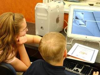Students looking at a computer while participating in the Mars Student Imaging Project