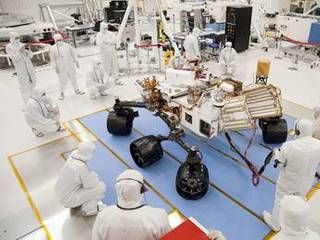 Technicians and engineers in clean-room garb monitor the first drive test of NASA's Curiosity rover, on July 23, 2010.