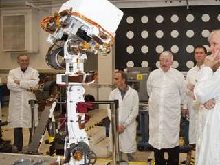 A group watching motions of an engineering model of the camera mast for NASA's Mars rover Curiosity on March 5, 2010, includes moviemaker James Cameron (right).