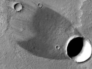 Wind shadow and real shadow combine to give a striking image of a comet.