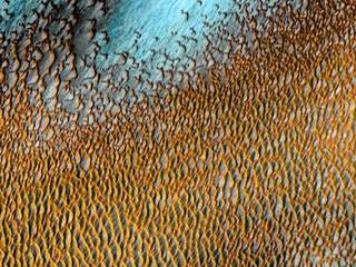 A sea of dark dunes, sculpted by the wind into long lines, surrounds the northern polar cap covering an area as big as Texas.