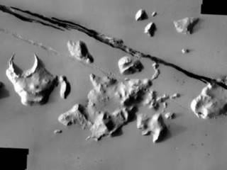 Geological faulting has opened cracks in the Cerberus region that slice through flat plains and mesas alike.