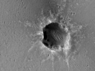 The High Resolution Imaging Science Experiment (HiRISE) camera on NASA's Mars Reconnaissance Orbiter acquired this image of the Opportunity rover on the southwest rim of "Santa Maria" crater on New Year's Eve 2010, or Martian day (sol) 2466 of the rover's work on Mars.