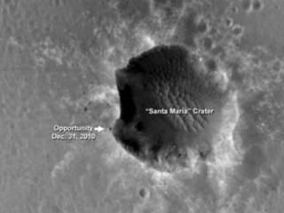 The High Resolution Imaging Science Experiment (HiRISE) camera on NASA's Mars Reconnaissance Orbiter acquired this image of the Opportunity rover on the southwest rim of "Santa Maria" crater on New Year's Eve 2010, or Martian day (sol) 2466 of the rover's work on Mars.