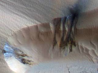 Three images of the same location taken at different times on Mars show seasonal activity causing sand avalanches and ripple changes on a Martian dune.