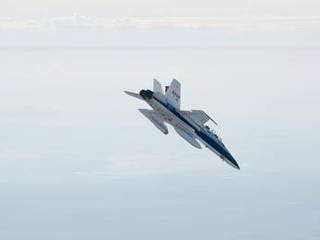 A NASA Dryden Flight Research Center F/A-18 852 aircraft makes a 40-degree dive toward Rogers Dry Lake at Edwards Air Force Base, Calif., during June 2011 flight tests of a Mars landing radar.