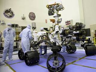 Technicians at the Payload Hazardous Servicing Facility at NASA's Kennedy Space Center in Florida, put the instrument mast and science boom on NASA's Mars Science Laboratory (MSL) rover, known as Curiosity, through a series of deployment tests.