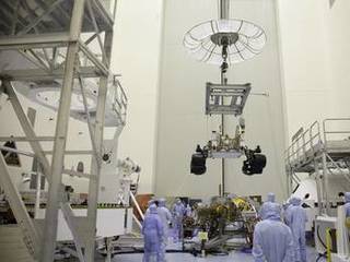 Technicians, at the Payload Hazardous Servicing Facility at NASA's Kennedy Space Center in Florida, use an overhead crane to move NASA's Mars Science Laboratory (MSL) rover, known as Curiosity, to the high bay floor where the instrument mast and science boom will undergo deployment testing.