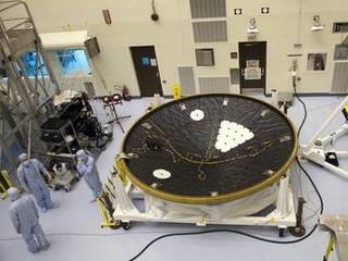 In the Payload Hazardous Servicing Facility at NASA's Kennedy Space Center in Florida, technicians process the heat shield for NASA's Mars Science Laboratory (MSL).