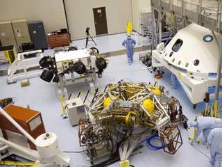 In the Payload Hazardous Servicing Facility at NASA's Kennedy Space Center in Florida, NASA's Mars Science Laboratory (MSL) rover, known as Curiosity, is being prepared to be moved to a rotation fixture for testing.