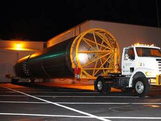 The first stage of the Atlas V rocket for NASA's Mars Science Laboratory (MSL) mission rolls out of the Atlas Spaceflight Operations Center on Cape Canaveral Air Force Station in Florida bound for the launch pad.