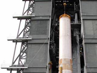 A crane lifts the 106.5-foot-long first stage of the Atlas V rocket for NASA's Mars Science Laboratory (MSL) mission through the open door of the Vertical Integration Facility at Space Launch Complex 41 on Cape Canaveral Air Force Station.