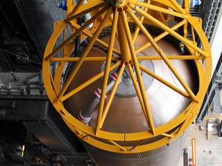 A crane positions the 106.5-foot-long first stage of the Atlas V rocket for NASA's Mars Science Laboratory (MSL) mission inside the Vertical Integration Facility at Space Launch Complex 41 on Cape Canaveral Air Force Station.