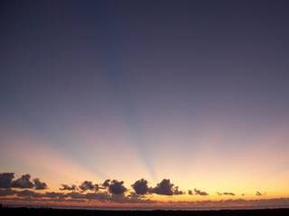 A beautiful sun rises on Florida's space coast as preparations are underway for mating the final solid rocket motor (SRM) to a United Launch Alliance Atlas V rocket at the Vertical Integration Facility at Space Launch Complex 41 on Cape Canaveral Air Force Station.