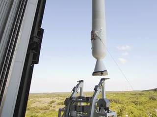 With a view taken from inside the Vertical Integration Facility at Space Launch Complex 41 on Cape Canaveral Air Force Station in Florida, the final solid rocket motor (SRM) hangs in an upright position for mating to a United Launch Alliance Atlas V rocket which will carry NASA's Mars Science Laboratory (MSL) mission.