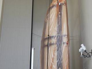 Half of the Atlas V payload fairing for NASA's Mars Science Laboratory (MSL) mission is lifted into a vertical position in the airlock of the Payload Hazardous Servicing Facility at NASA's Kennedy Space Center in Florida.