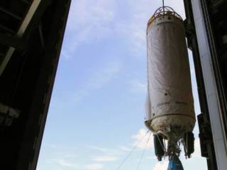 With a unique view taken from inside Vertical Integration Facility (VIF) at Launch Complex 41 at Cape Canaveral Air Force Station in Florida, an overhead crane lifts the Centaur upper stage for the United Launch Alliance Atlas V.