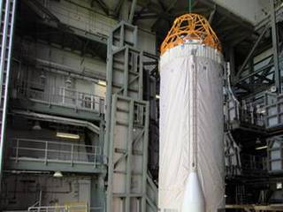 At Launch Complex 41 at Cape Canaveral Air Force Station in Florida, workers guide an overhead crane as it lifts the Centaur upper stage for the United Launch Alliance Atlas V in the Vertical Integration Facility (VIF).