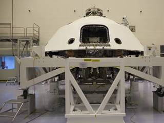 In the Payload Hazardous Servicing Facility at NASA's Kennedy Space Center in Florida, the backshell, a protective cover which carries the parachute and several components used during later stages of entry, descent and landing, has been encapsulated over NASA's Mars Science Laboratory (MSL) rover, Curiosity.