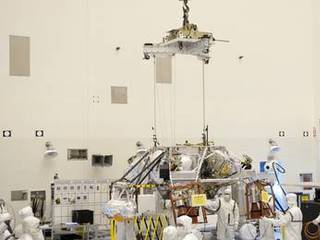 Technicians, at the Payload Hazardous Servicing Facility at NASA's Kennedy Space Center in Florida, use an overhead crane to move a rocket-powered descent stage for integration with NASA's Mars Science Laboratory (MSL) rover, known as Curiosity.