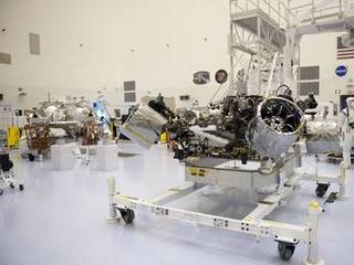 At the Payload Hazardous Servicing Facility at NASA's Kennedy Space Center in Florida, NASA's Mars Science Laboratory (MSL) rover, known as Curiosity, will be integrated with a rocket-powered descent stage (shown here to the left of the rover).
