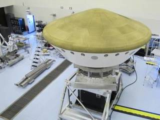 At the Payload Hazardous Servicing Facility at NASA's Kennedy Space Center in Florida, the Mars Science Laboratory rover, Curiosity, and the spacecraft's descent stage have been enclosed inside the spacecraft's aeroshell.