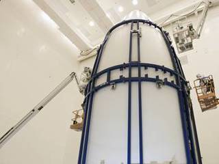 In the Payload Hazardous Servicing Facility at NASA's Kennedy Space Center in Florida, spacecraft technicians secure an Atlas V rocket payload fairing around NASA's Mars Science Laboratory (MSL).