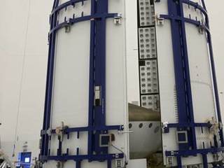 In the Payload Hazardous Servicing Facility at NASA's Kennedy Space Center in Florida, sections of an Atlas V rocket payload fairing obscure NASA's Mars Science Laboratory (MSL) from view as they close in around it.