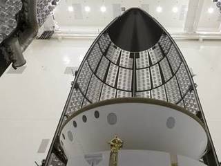 In the Payload Hazardous Servicing Facility at NASA's Kennedy Space Center in Florida, sections of an Atlas V rocket payload fairing engulf NASA's Mars Science Laboratory (MSL) as they close in around it.