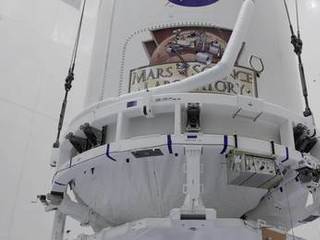 The Atlas V payload fairing containing NASA's Mars Science Laboratory (MSL) spacecraft rises above the floor of the Payload Hazardous Servicing Facility at Kennedy Space Center in Florida.