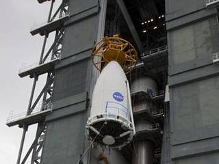Employees at Space Launch Complex 41 of Cape Canaveral Air Force Station, Fla., keep watch as the payload fairing containing NASA's Mars Science Laboratory spacecraft is lifted up the side of the Vertical Integration Facility on Nov. 3, 2011.