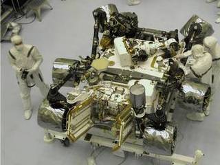 The Mars Science Laboratory mission's rover, Curiosity, is prepared for final integration into the complete NASA spacecraft in this photograph taken inside the Payload Hazardous Servicing Facility at NASA Kennedy Space Center, Fla.