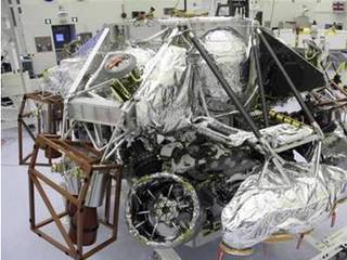 The Mars Science Laboratory mission's "powered descent vehicle" is the integrated combination of the spacecraft's descent stage and the rover Curiosity. It is shown inside the Payload Hazardous Servicing Facility at NASA Kennedy Space Center, Fla. in this photograph taken during final assembly of the spacecraft.