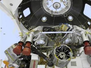 The "powered descent vehicle" of NASA's Mars Science Laboratory spacecraft is being prepared for final integration into the spacecraft's back shell in this photograph from inside the Payload Hazardous Servicing Facility at NASA Kennedy Space Center, Fla. The powered descent vehicle combines the spacecraft's descent stage and the rover Curiosity.