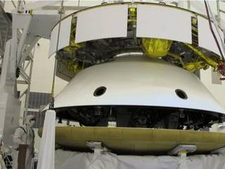 During final stacking of NASA's Mars Science Laboratory spacecraft, the heat shield is positioned for integration with the rest of the spacecraft in this photograph from inside the Payload Hazardous Servicing Facility at NASA Kennedy Space Center, Fla.
