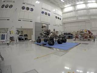 NASA's Curiosity rover and its powered descent vehicle pose for photographs prior to being integrated for launch at JPL's Spacecraft Assembly Facility.