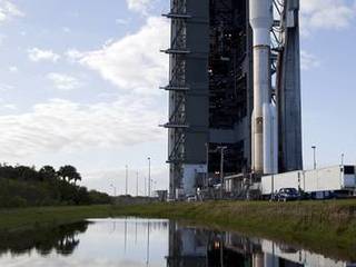 On Cape Canaveral Air Force Station in Florida, the 197-foot-tall United Launch Alliance Atlas V rocket moves away from the Vertical Integration Facility (VIF) during the vehicle's rollout to the launch pad at Space Launch Complex 41.