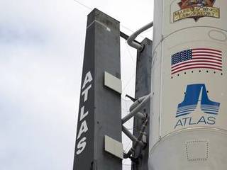 The NASA and Mars Science Laboratory (MSL) logos appear above the American flag and Atlas logo on the payload fairing atop the 197-foot-tall United Launch Alliance Atlas V rocket.