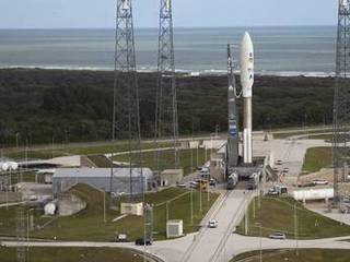 On Cape Canaveral Air Force Station in Florida, the 197-foot-tall United Launch Alliance Atlas V rocket is in place at Space Launch Complex 41 after rolling out from the nearby Vertical Integration Facility (VIF).