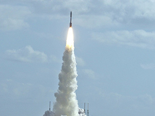 With NASA's Mars Science Laboratory (MSL) spacecraft sealed inside its payload fairing, the United Launch Alliance Atlas V rocket rides a pillar of smoke and flames as it lifts off from Space Launch Complex-41 on Cape Canaveral Air Force Station in Florida at 10:02 a.m. EST Nov. 26.