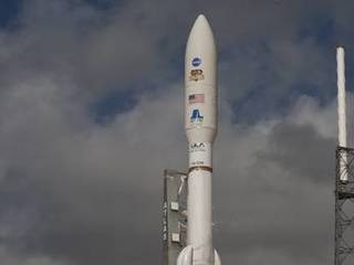 With NASA's Mars Science Laboratory (MSL) spacecraft sealed inside its payload fairing, the United Launch Alliance Atlas V rocket rides smoke and flames as it rises from the launch pad at Space Launch Complex-41 on Cape Canaveral Air Force Station in Florida at 10:02 a.m.