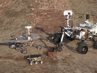 This grouping of two test rovers and a flight spare provides a graphic comparison of three generations of Mars rovers developed at NASA's Jet Propulsion Laboratory, Pasadena, Calif. The setting is JPL's Mars Yard testing area.