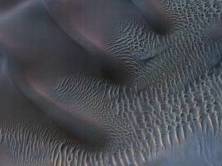 This enhanced-color image shows sand dunes trapped in an impact crater in Noachis Terra, Mars.