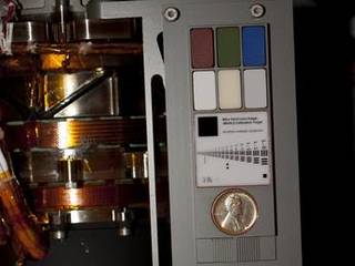 Two instruments at the end of the robotic arm on NASA's Mars rover Curiosity will use calibration targets attached to a shoulder joint of the arm.